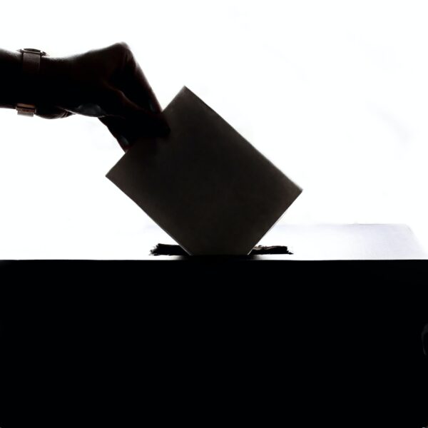 Hand dropping ballot in a ballot box